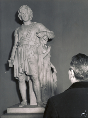 En gæst på Thorvaldsens Museum foran Bertel Thorvaldsens selvportrætstatue fra 1839